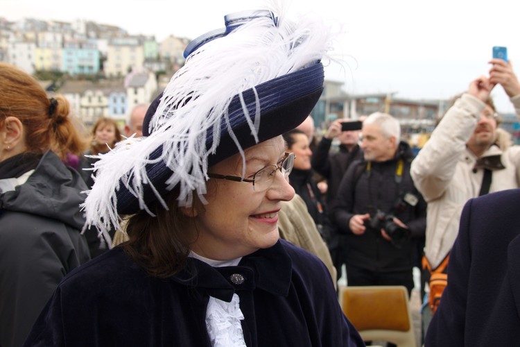 dignitary in feathered hat