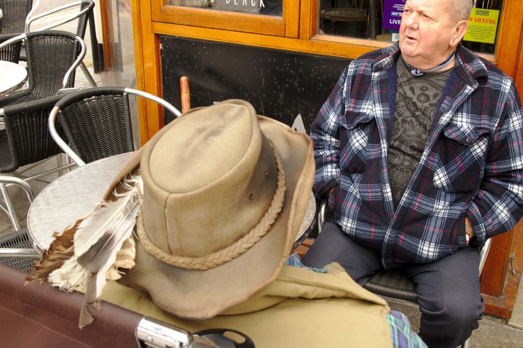man in feathered hat