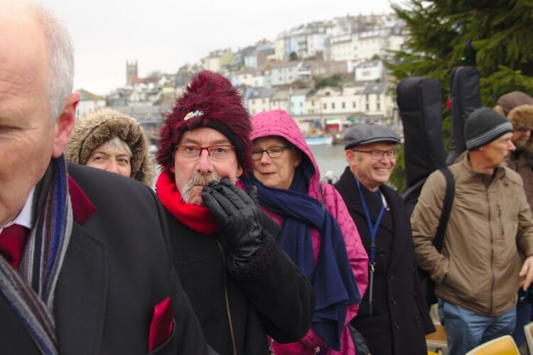 street photography hat gloved hand to mouth