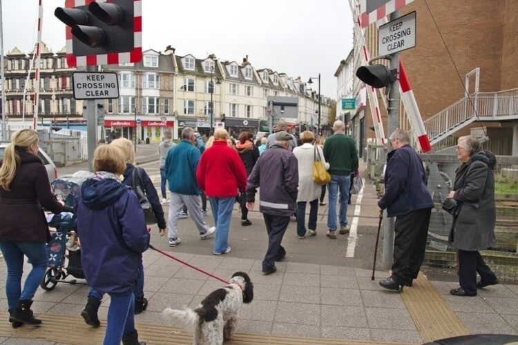 humorous crowds crossing railway